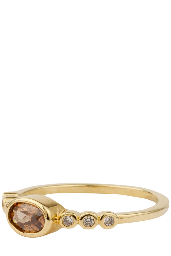 The ellips ring in gold and brown colour from the brand ALL THE LUCK IN THE WORLD