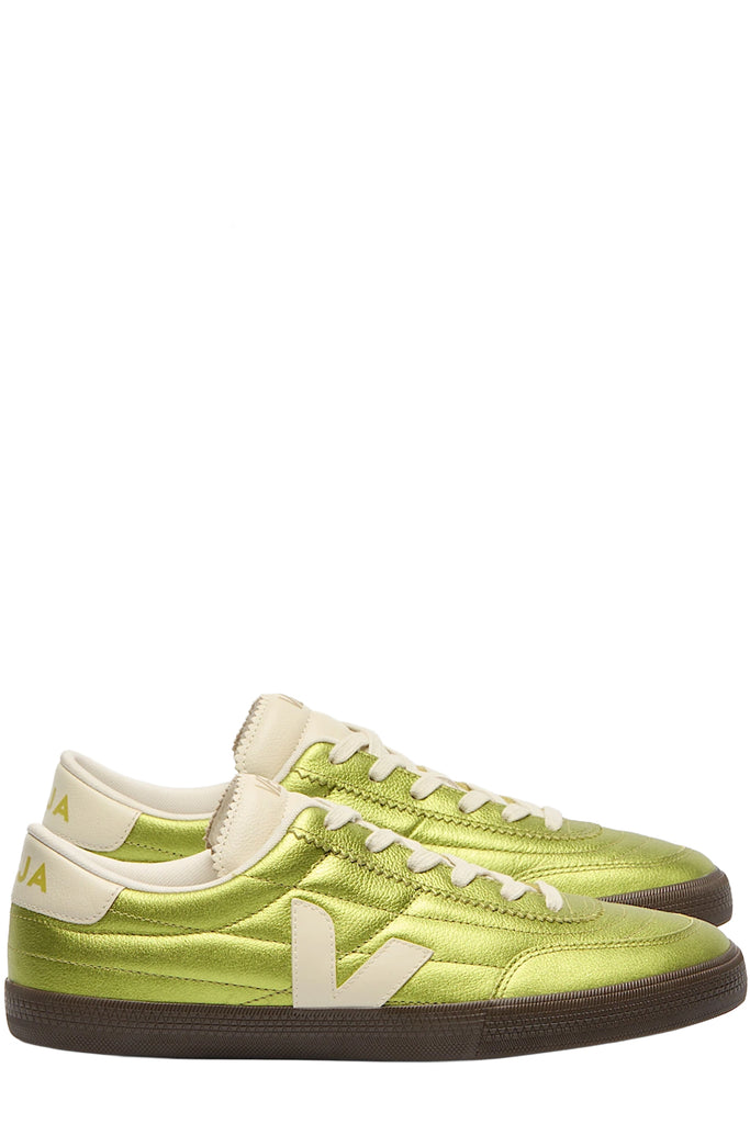 A pair of Veja sneakers in metallic green with seamlines made from leather shown against a plain white background.