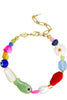 A gold-tone chain bracelet with colorful, organic-shaped beads, including a green fish bead, a white daisy, and blue evil eye beads, shown on a plain white background.