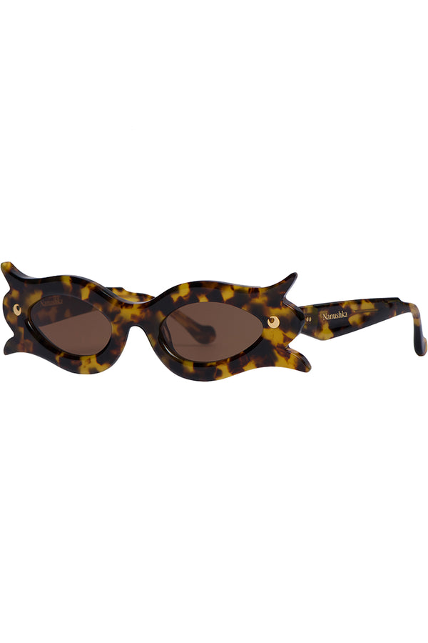 Cat-eye sunglasses with a glossy tortoiseshell frame in brown and yellow, featuring dark brown lenses and a small gold logo on the temple arm.
