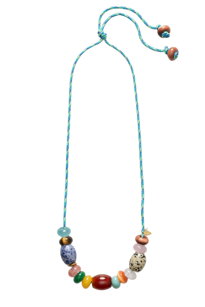 A beaded necklace with a turquoise-blue braided cord and a series of colorful, patterned beads including a blue-and-white spotted bead, a red oval bead, and a speckled cream bead, shown on a plain white background.