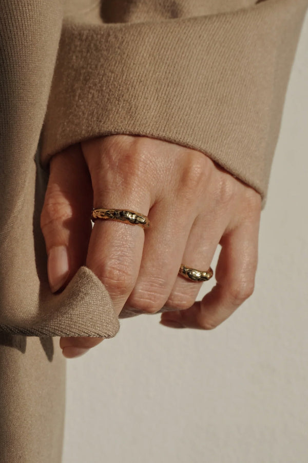 Model wearing the Stratum ring in gold colour from the brand ANITA BERISHA