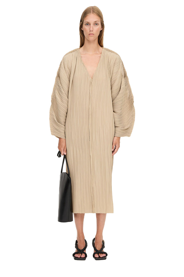 Model wearing the Dalya asymmetric volume-sleeve dress in beige color from the brand BY MALENE BIRGER
