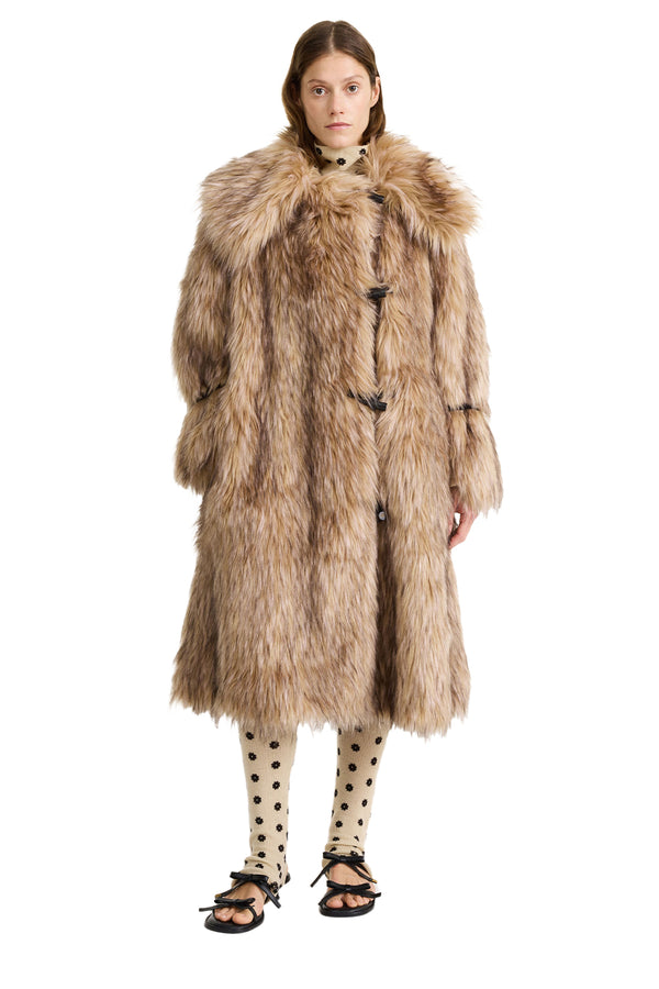 Model wearing the Graca Faux Fur Coat in beige colour from the brand BY MELENE BIRGER