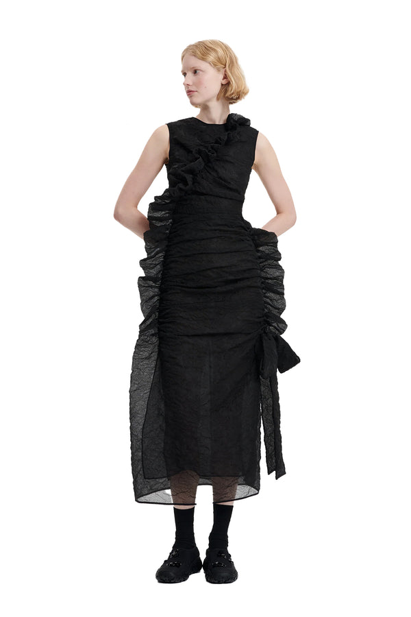 Model wearing the Gabriella Long Sleeveless Dress With Asymmetrical Ruffles in black colour from the brand CECILIE BAHNSEN