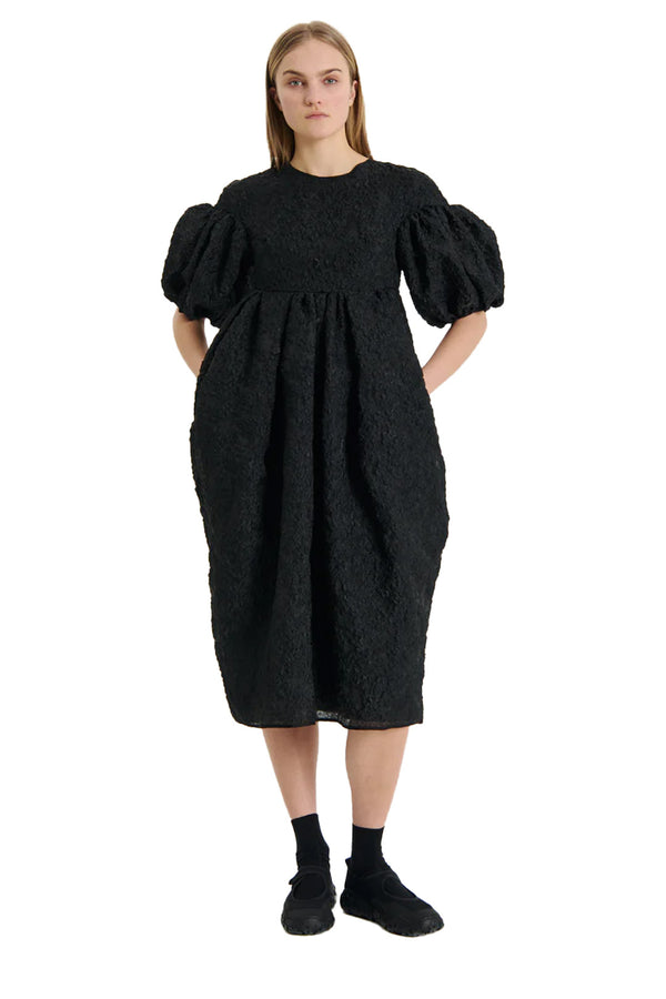 Model wearing the Jeanne Puff-Sleeve Dress in black colour from the brand CECILIE BAHNSEN