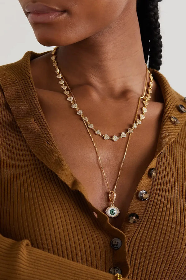 Model wearing the fortuna pendant with pave connector in gold color from the brand CRYSTAL HAZE