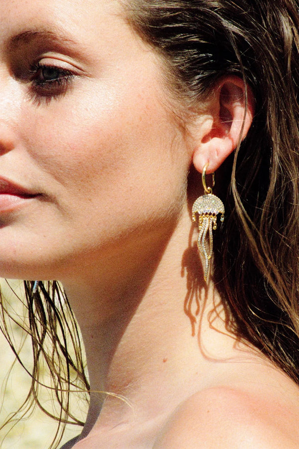 Model wearing the Octopus single earring in gold color from the brand CRYSTAL HAZE