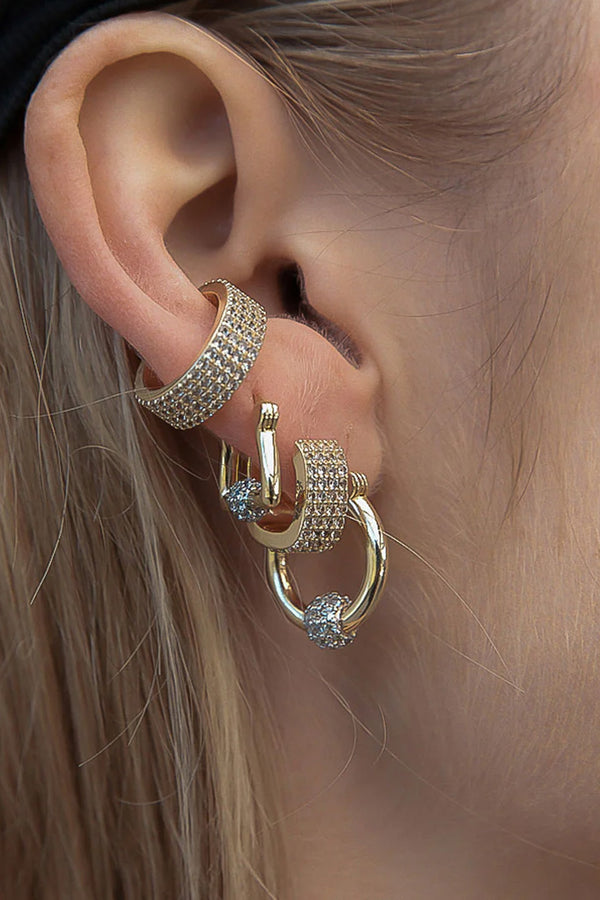 Model wearing the disco gemstone huggie earrings in gold and clear colour from the brand F+H JEWELLERY