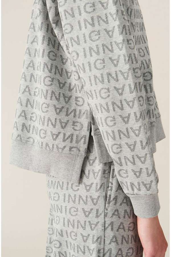 Model wearing the all-over logo-print sweatshirt in melange grey color from the brand GANNI.