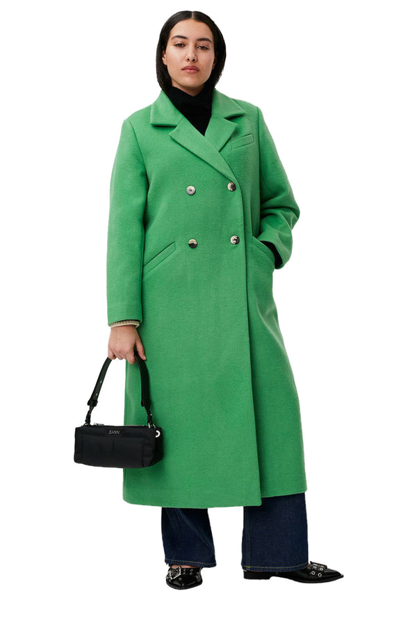 Model wearing the double-breasted recycled wool coat in kelly green color from the brand GANNI.