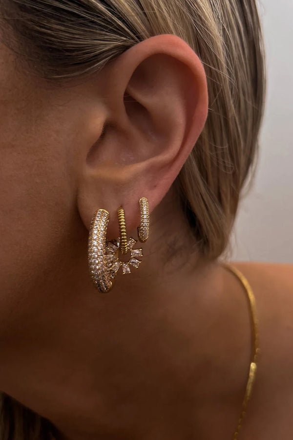 Model wearing the reversible mini Amalfi hoop earrings in gold colour from the brand LUV AJ