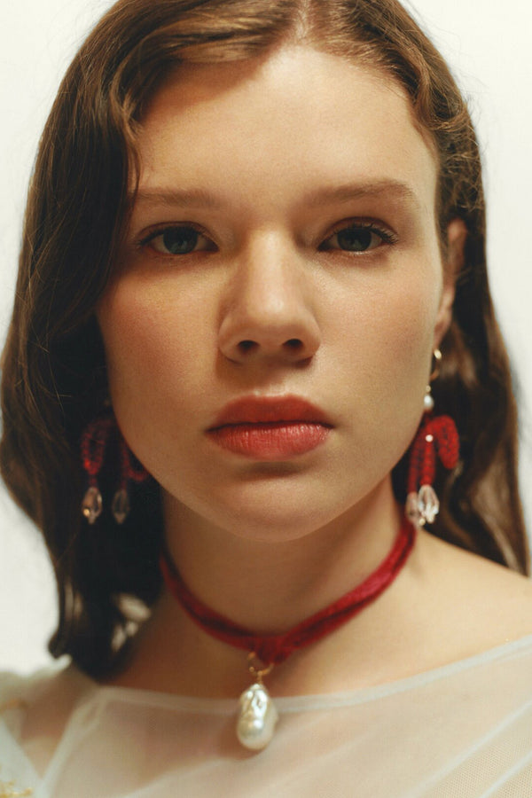 Model wearing the Agatha necklace gold and red colours from the brand MARGAUX STUDIOS