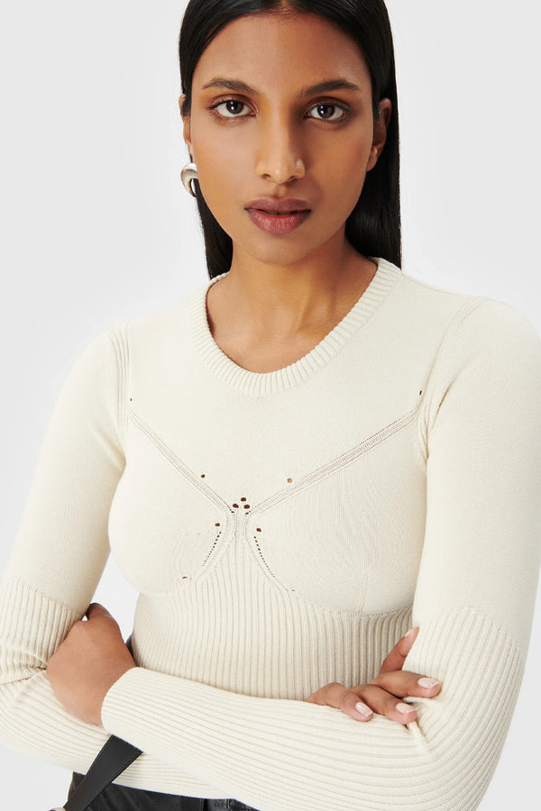 Model wearing the ribbed-knit long-sleeve top in beige color from the brand MARINE SERRE