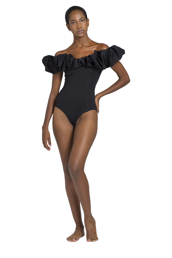 Model wearing the Mia ruffled off-the-shoulder swimsuit in black color from the brand MAYGEL CORONEL