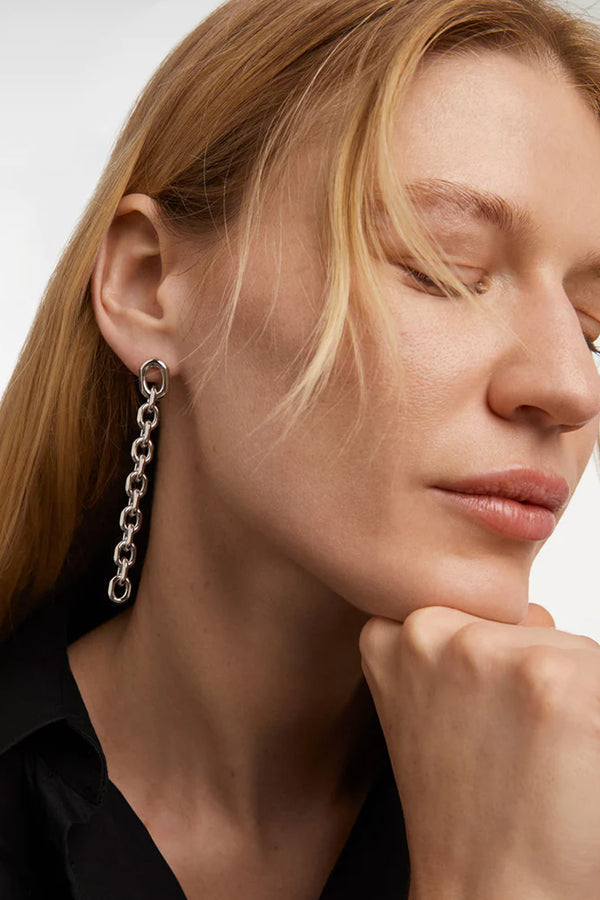 Model wearing the Vesta earrings in silver colour from the brand P D PAOLA