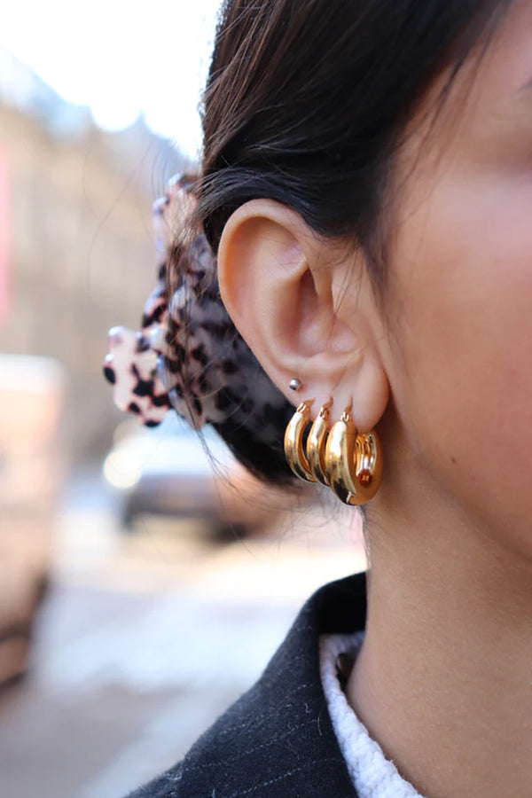 Model wearing the Amanda medium hoop earrings in gold colour from the brand PICO COPENHAGEN
