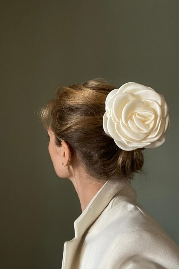 Model wearing the giant satin rose claw clip in ivory colour from the brand PICO