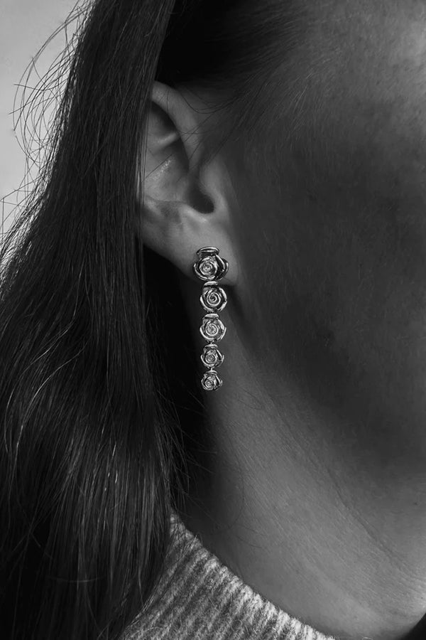 Model wearing the Rose Quintet stud earrings in silver colour from the brand PICO COPENHAGEN