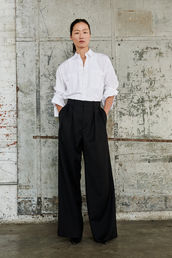 Model wearing the Low-Rise Tapered Wide-Leg Pants in black colour from the brand Wardrobe.NYC