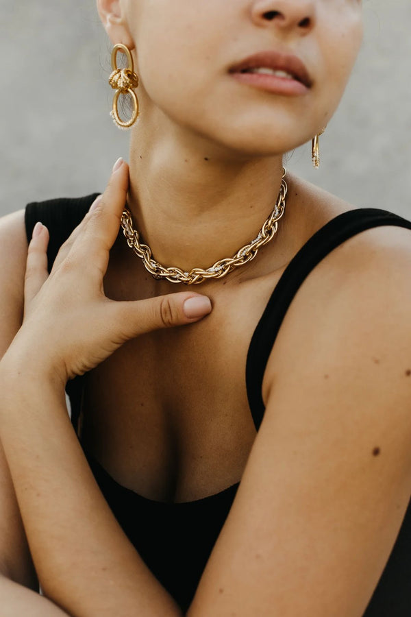 Model wearing the Karen multi-link twisted choker in gold color from the brand GISEL B.