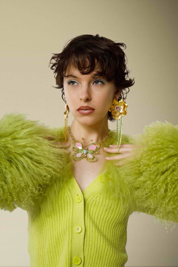 Model wearing the Cocktail earrings in green color from the brand MAYOL JEWELRY